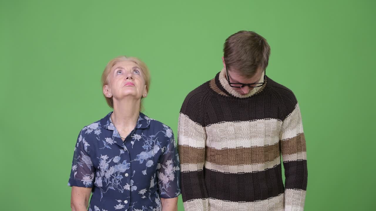 Grandmother looking up and grandson looking down together