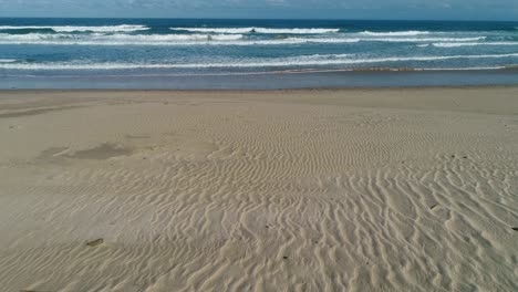 aerial view of a pristine scenic sandy beach with breaking waves, south africa