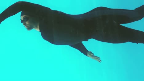 athletic man swimming underwater