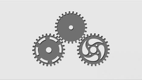 three  rotating gears cut out in light gray background