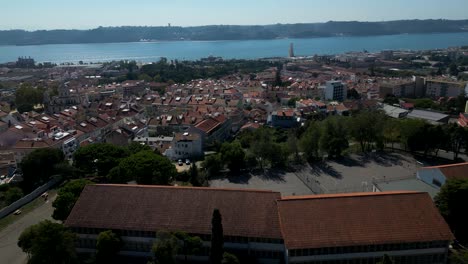 Aerial-tilt-down-shot-of-Lisbon-City-with-Rio-Tejo-River-during-sunny-day-in-Portugal