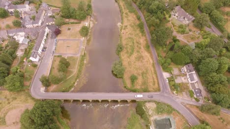 a static flight over a beautiful flowing river and an old brick bridge