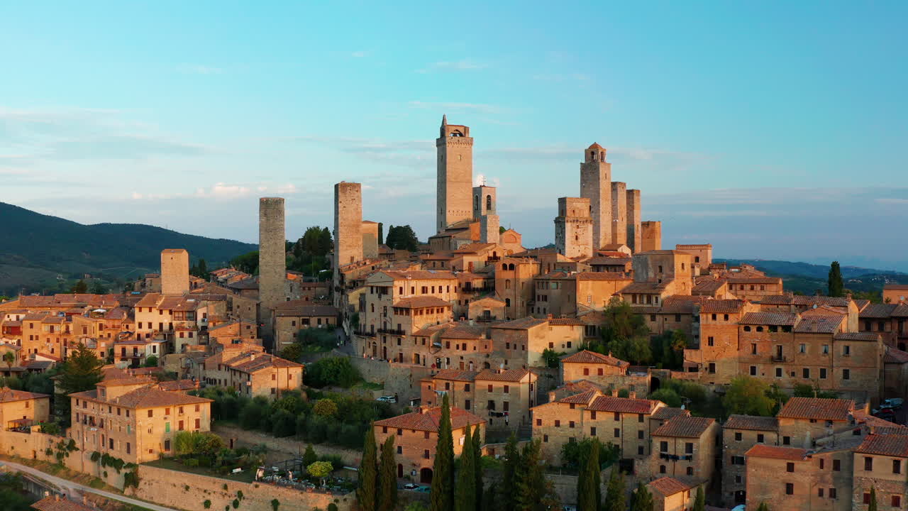 Dolly in aerial of the towers of San Gimignano in Tuscany Italy,  Sunrise shot with drone.