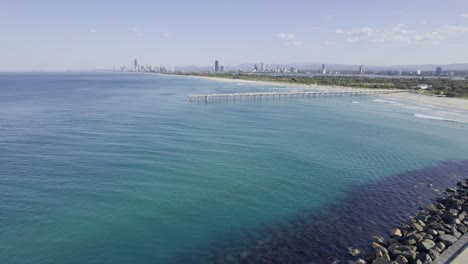 lighthouse at seawall - sand bypass pumping jetty system at main beach in qld, australia