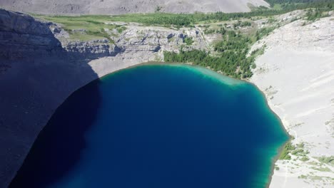 aerial top down blue green water carnarvon lake, kananaskis, alberta, canada