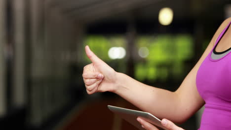 female trainer checking results on tablet