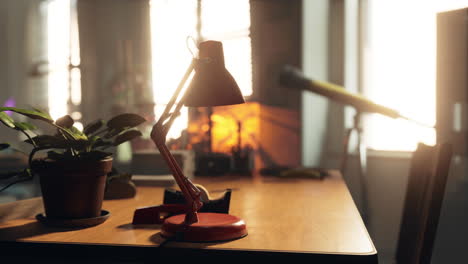 red desk lamp on a wooden desk in a home office