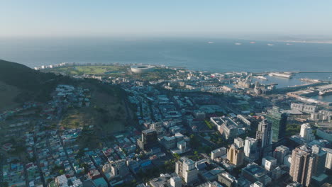 Aerial-panoramic-footage-of-various-buildings-in-urban-neighbourhood-on-seaside.-Revealing-high-rise-buildings-in-city-centre.-Cape-Town,-South-Africa