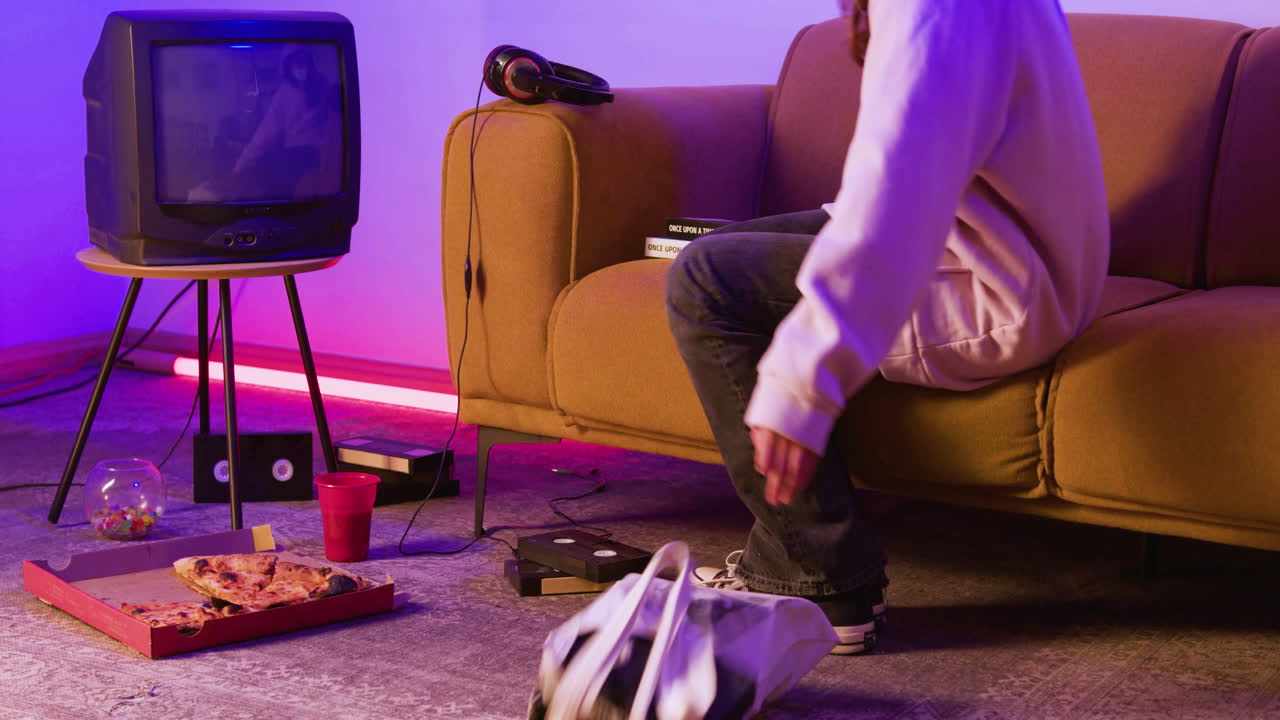 Living room with sofa, televisi&oacute;n and VHS cassettes