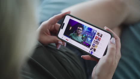 woman watching video on smartphone