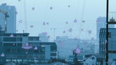animation of network of digital icons against aerial view of cityscape
