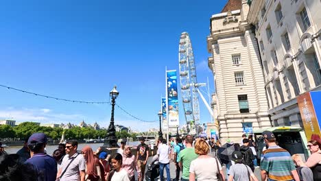 crowds gather near iconic ferris wheel attraction