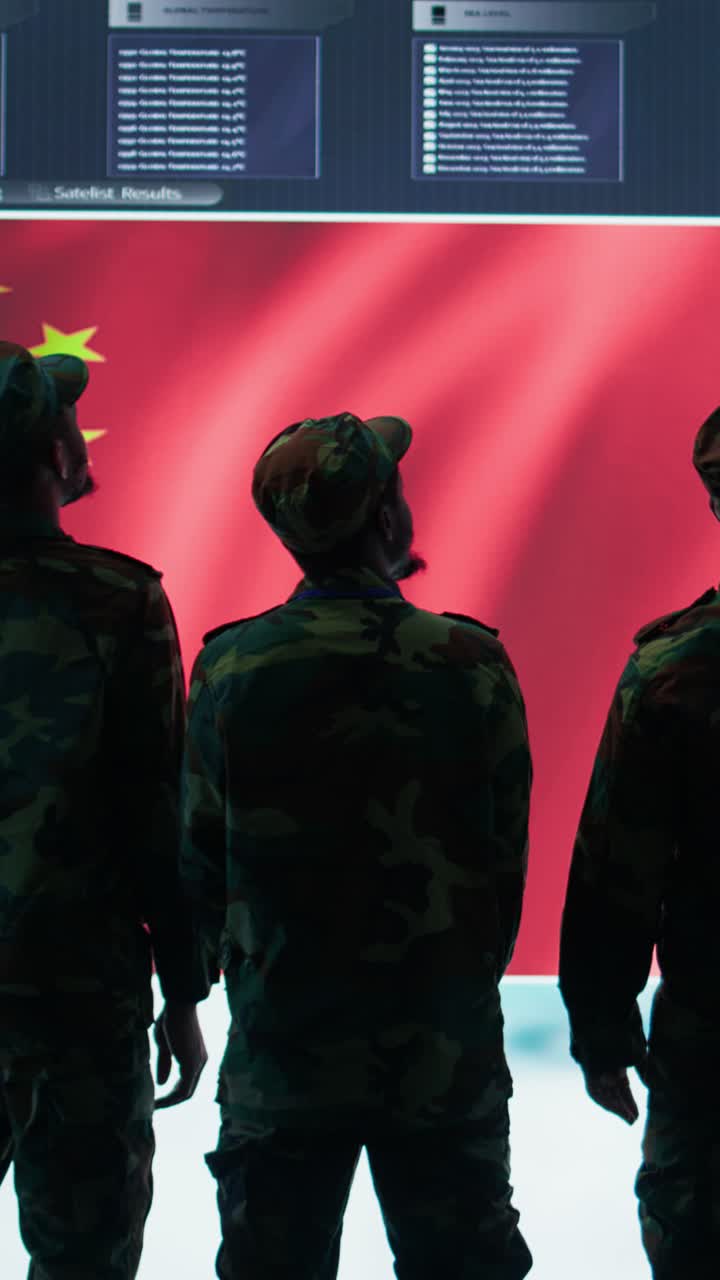Vertical Video Cybersecurity specialist in Chinese military command post analyzes data to inflict fear