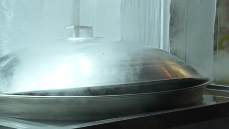 steam rising over steamer - cooking mandu - mangwon market in seoul, south korea. - closeup shot