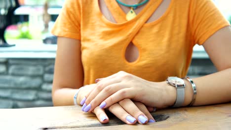 the girl looks at her watch. close-up. the girl waits