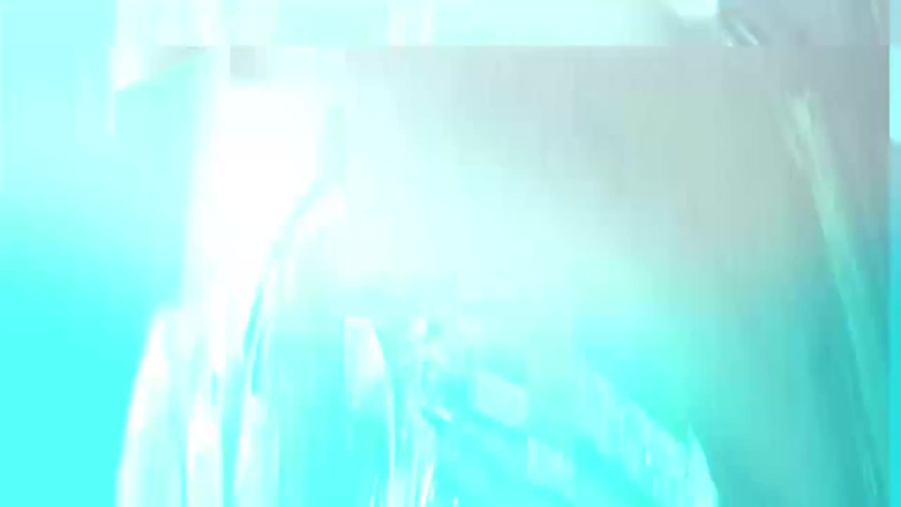 Woman laughing at her phone outdoors