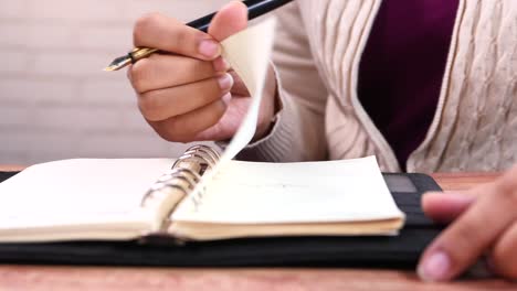 person writing in a notebook