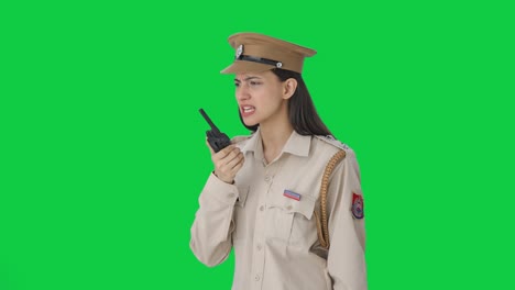 Angry-Indian-female-police-officer-shouting-on-walkie-talkie-Green-screen