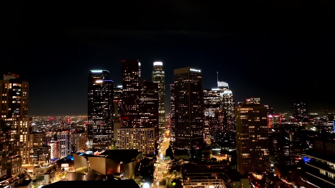 The iconic Los Angeles city skyline at night - rising aerial view
