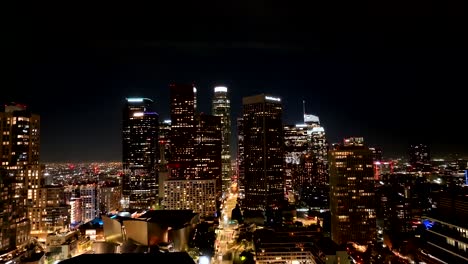 the iconic los angeles city skyline at night - rising aerial view