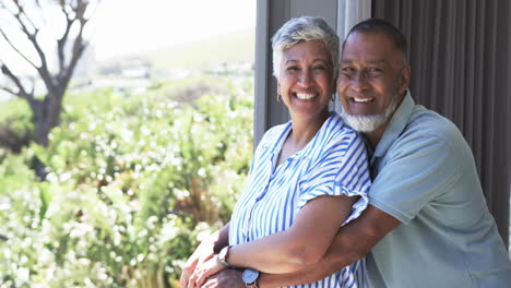 Biracial-couple-smiles-warmly,-standing-outdoors