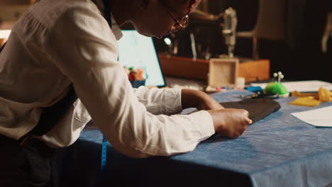 tailor measuring fabric in workshop