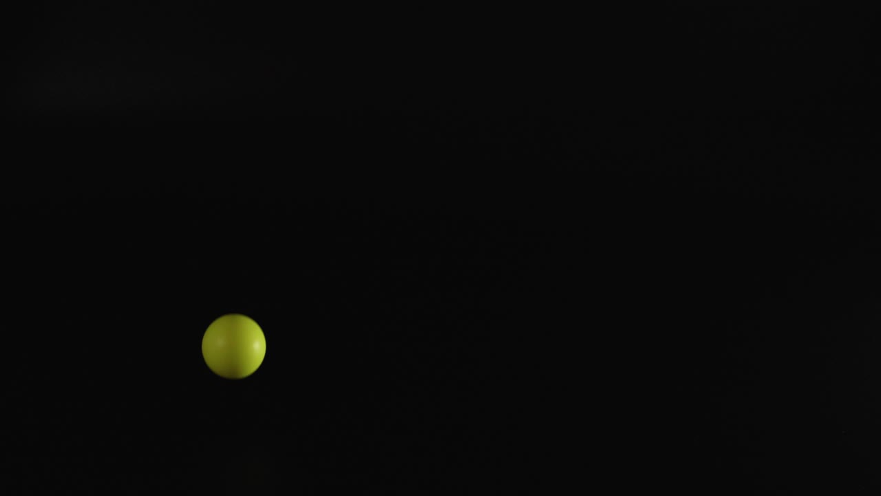 Multiple colored balls bouncing in a dark space