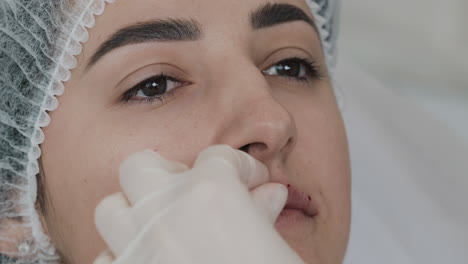 woman receives lip augmentation injections in a beauty clinic