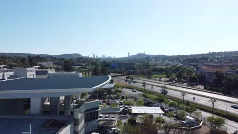 bedfordview, johannesburg - a cinematic aerial reveal shot of the city of johannesburg on a sunny day in gauteng, south africa