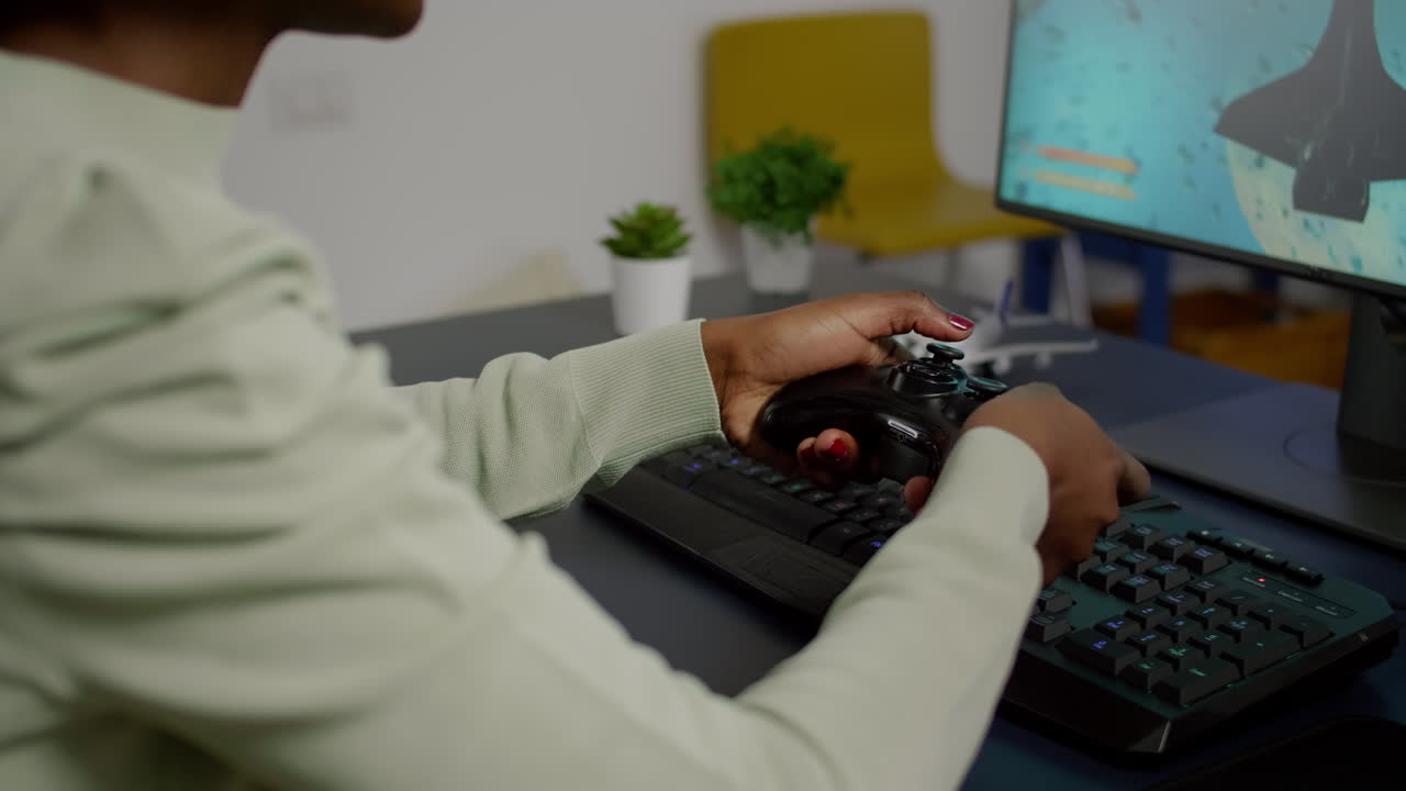 Closeup of wireless joystick and RGB keyboard, pro video gamer playing
