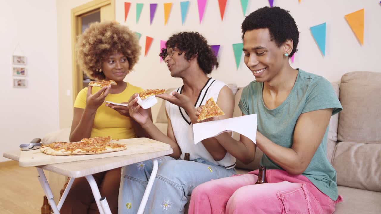 People eating pizza at a party