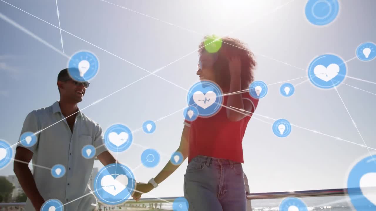 animación de la red de conexiones con iconos de corazón sobre una pareja en la playa