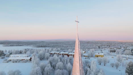 aerial view toward the cross on the salla church, winter sunrise in finland