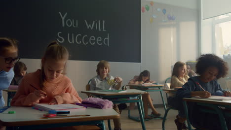 pupils learning in classroom. female and male students sitting at desks