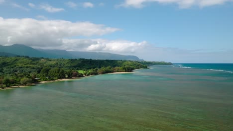 wide aerial shot orbiting and moving away from anini beach, kauai, hawaii