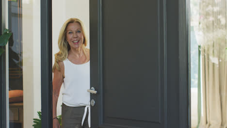 caucasian woman opening the entrance door