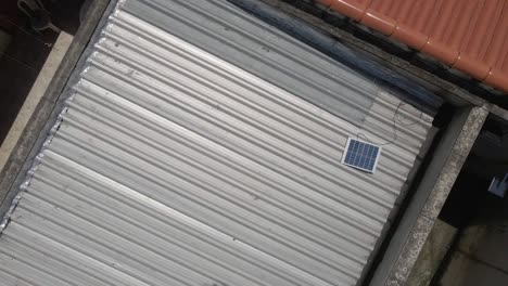 aerial view of a simple humble house with solar panel on the rooftop environment