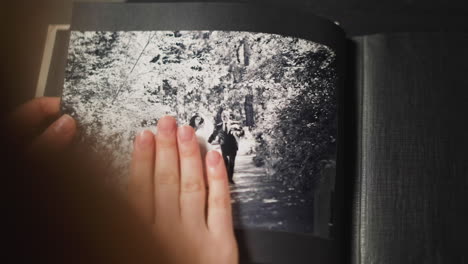 woman looks at vintage picture of grandparents wedding