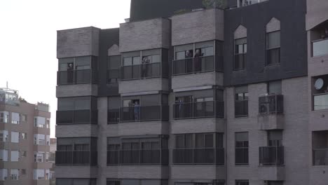 people on balconies of a multi-story building