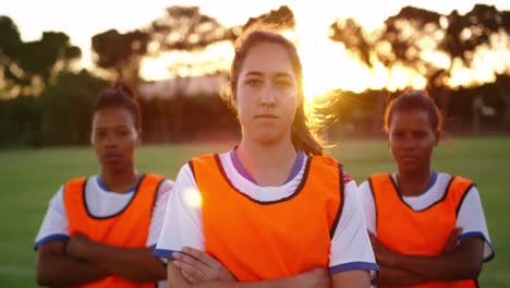 female soccer players standing with arms crossed on soccer field. 4k