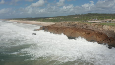 flying towards rocky cliff with wild waves slamming into them