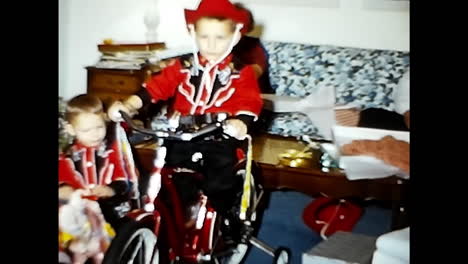 man riding bike next to little boy in 1970s usa. circa usa - 1970s: a man is seen riding a bike alongside a small boy in this 1970s video archive from the united states.