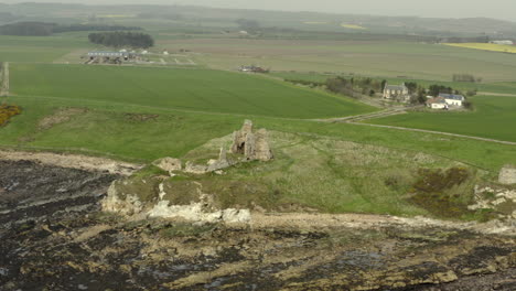 an aerial view of newark castle on the fife coastal path, scotland