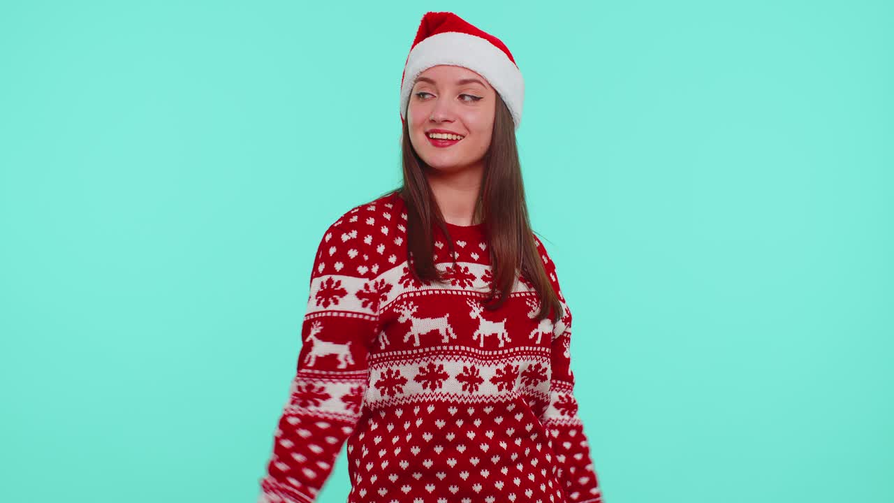 Young adult girl in christmas sweater listening music dancing disco fooling around having fun
