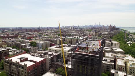360 panning drone shot of manhattan construction project, nyc skyline in background