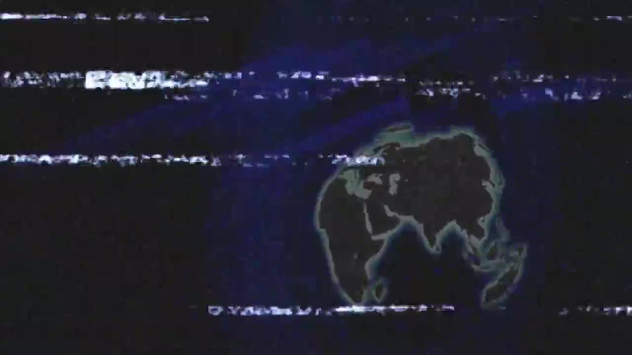 Glitch statico che avvia la rotazione su sfondo blu navy, mentre la Terra luminosa gira e visualizza un ciclo.