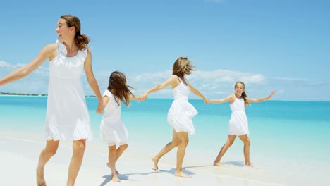 loving caucasian mother and daughters together on beach