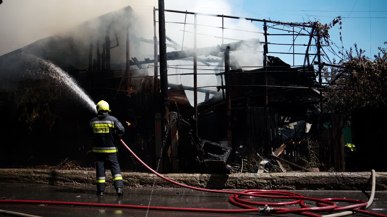 Firefighter trying to extinguish a house on fire