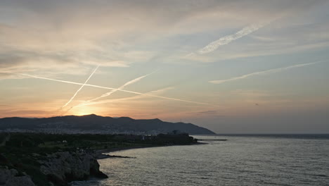 Time-Lapse-of-golden-hour-sun-rise-over-the-majestic-mountain-ridge-near-the-picturesque-coastal-city