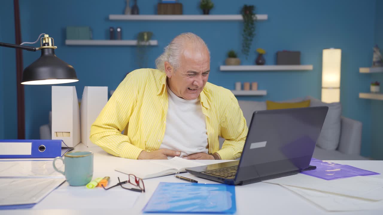 Home office worker old man has stomachache.